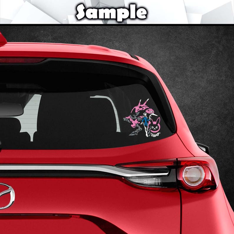 May include: A vinyl decal applied to the rear window of a red car. The decal features a graphic illustration of a character in a blue suit standing next to a large pink mechanical figure, accompanied by a pink rabbit icon and the text D.Va.