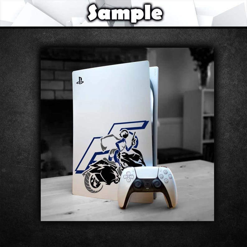 May include: A white PlayStation 5 console with a blue and black decal of a person riding a motorcycle. The console is sitting on a wooden surface next to a white PlayStation 5 controller.
