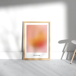 May include: A framed print with a blurred abstract design in shades of pink, orange, and yellow. The text "Embrace good change" is printed at the bottom of the print.