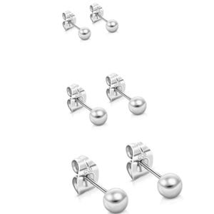May include: Three pairs of silver stud earrings with a small round ball at the end of each post. The earrings are designed for pierced ears.