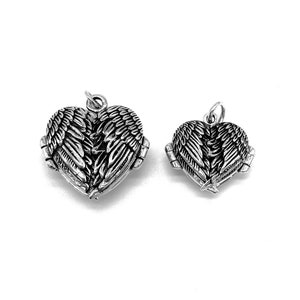 May include: Two silver heart-shaped lockets with angel wings. The lockets are open and the wings are spread out. The larger locket is on the left and the smaller locket is on the right.