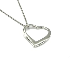 May include: A silver necklace with a simple open heart pendant.