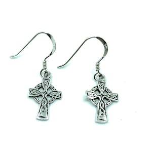 May include: A pair of silver Celtic cross earrings with intricate knotwork designs. The earrings have a hook closure.