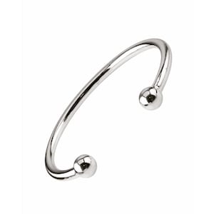May include: A silver bangle bracelet with two round balls at the ends.