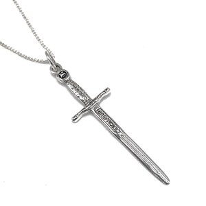 May include: A silver necklace with a sword pendant. The sword is engraved with the word "Excalibur".