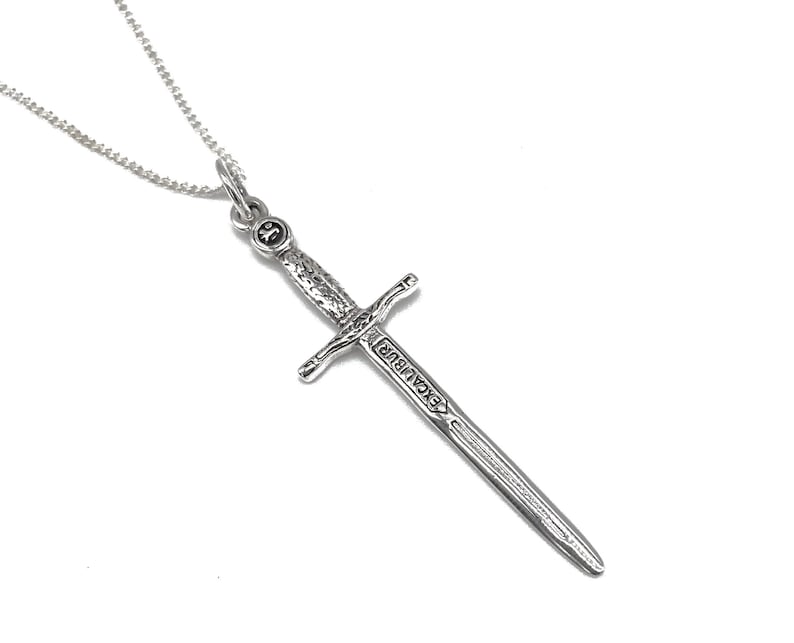 May include: A silver necklace with a sword pendant. The sword is engraved with the word "Excalibur".