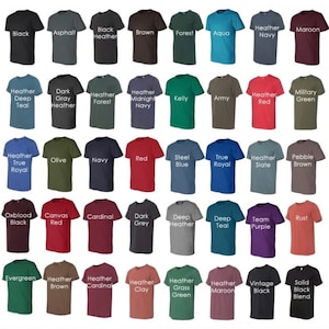 May include: A chart of 40 different t-shirt colors, including black, white, red, blue, green, and many shades of heather. The colors are displayed on folded t-shirts.