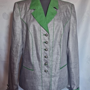 May include: A grey blazer with a green collar, green piping accents, and six silver-toned metal buttons down the front. The blazer features long sleeves with green cuffs, each finished with two small silver-toned metal buttons at the wrists.