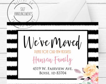 May include: Black and white striped card with the text "We've Moved" and the words "Please note our new address" in smaller font. The text "Hansen Family" is in pink and the address "4519 W. Fairview Ave. Boise, ID 83704" is in black. The card is decorated with a floral design in the bottom right corner.