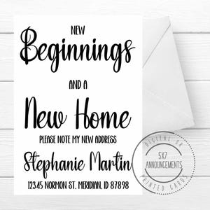 May include: A white announcement card with the text "New Beginnings and a New Home." The card includes the name "Stephanie Martin" and an address. A white envelope is visible on the right side.