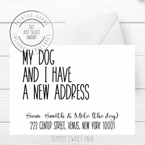 May include: A white card with black text that reads "My dog and I have a new address." Below the text is the name "Sam Smith & Milo (the dog)" and the address "223 Center Street, Venus, New York 10001". The bottom of the card reads "Simply Sweet Ink".