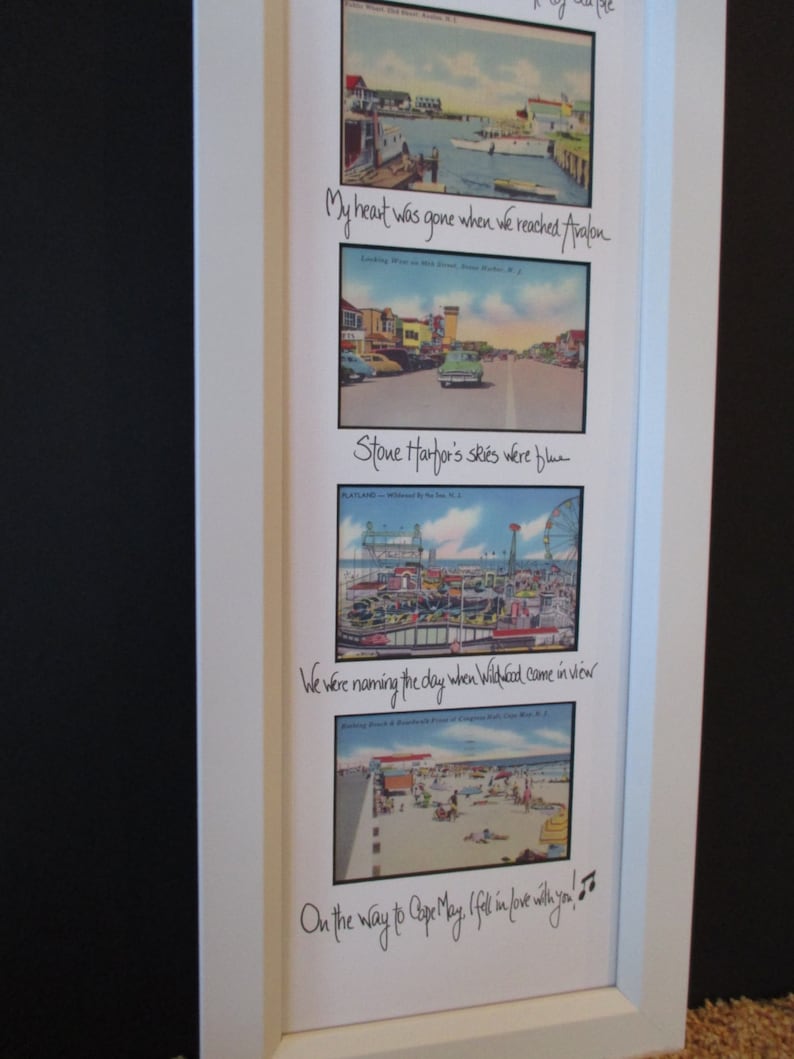 May include: A white framed collage of vintage postcards with handwritten text. The text reads "My heart was gone when we reached Avalon", "Stone Harbor's skies were blue", "We were naming the day when Wildwood came in view", and "On the way to Cape May, I fell in love with you!"