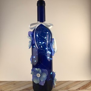 Blue bottle with blue and yellow flowers