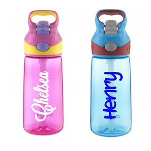 May include: Two personalized water bottles with flip top lids and straws. The bottle on the left is pink with the name "Chelsea" in white lettering. The bottle on the right is blue with the name "Henry" in blue lettering.