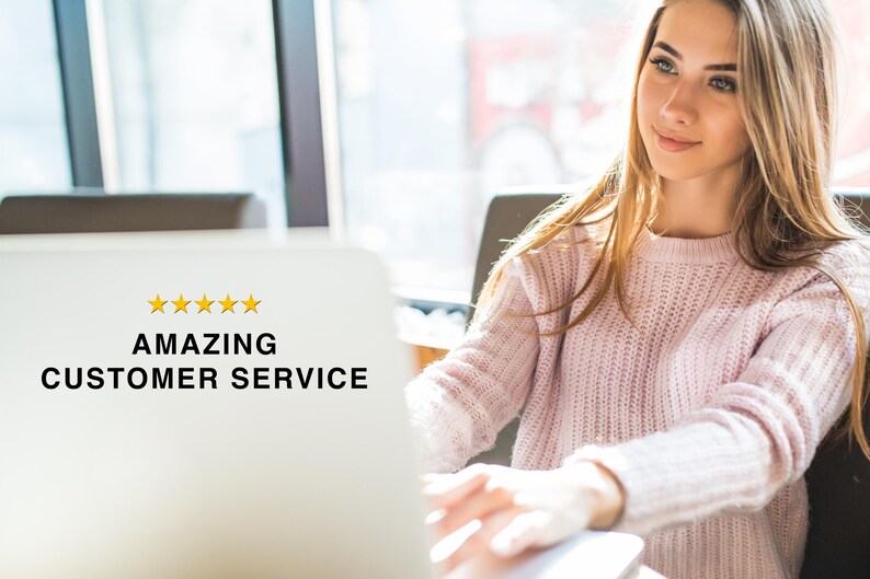May include: A white laptop screen displaying five yellow stars and the black text AMAZING CUSTOMER SERVICE. The screen is positioned in front of a person wearing a light pink knitted jumper, who is looking toward the side of the laptop.