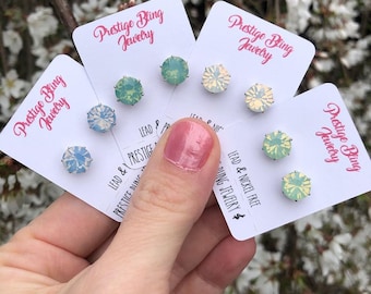 May include: Four pairs of iridescent earrings on white cards with the text "Prestige Bling Jewelry" and "Lead & Nickel Free". The earrings are in shades of green, blue, and white.