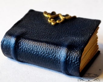 Miniature leather book. Dark navy aged faux leather, decorated with brass, round spine, two raised bands. Paper non-openable pages-Dollhouse