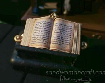 Miniature tiny open book-dollhouse miniatures-tiny little mini book-plain-text-empty glued pages inside-fantasy setting-library-desk-diorama