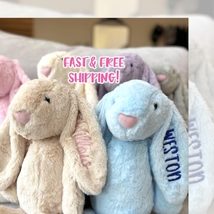 May include: A set of three ceramic mugs with a speckled, matte finish. The mugs are in shades of cream, light gray, and dark gray. Each mug has a simple, minimalist design and a rounded handle.