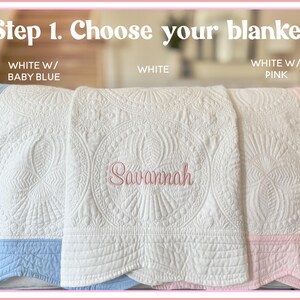 May include: Three quilted blankets with scalloped edges and intricate stitching. The text reads Step 1. Choose your blanket. Labels indicate White w/ Baby Blue, White, and White w/ Pink. The center blanket features the embroidered name Savannah.