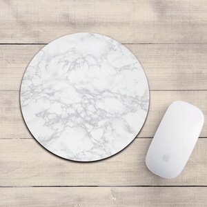 May include: White round mouse pad with a marble pattern.