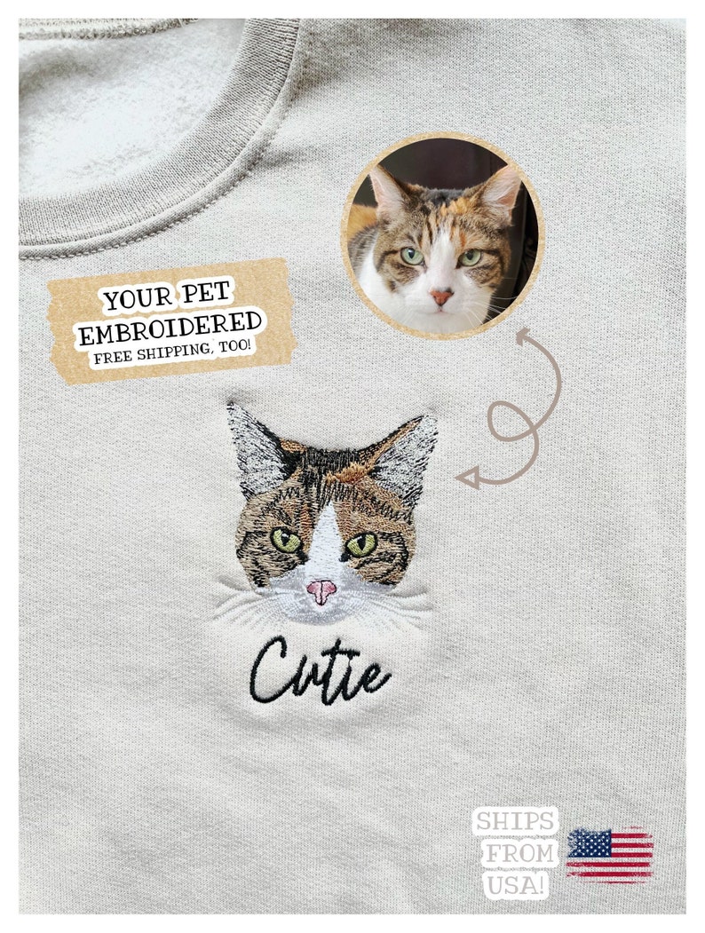 Puede incluir: Sudadera gris claro con un bordado de la cara de un gato y la palabra "Cutie" debajo. Una imagen circular de un gato est&aacute; al lado del bordado. La sudadera tiene cuello redondo.