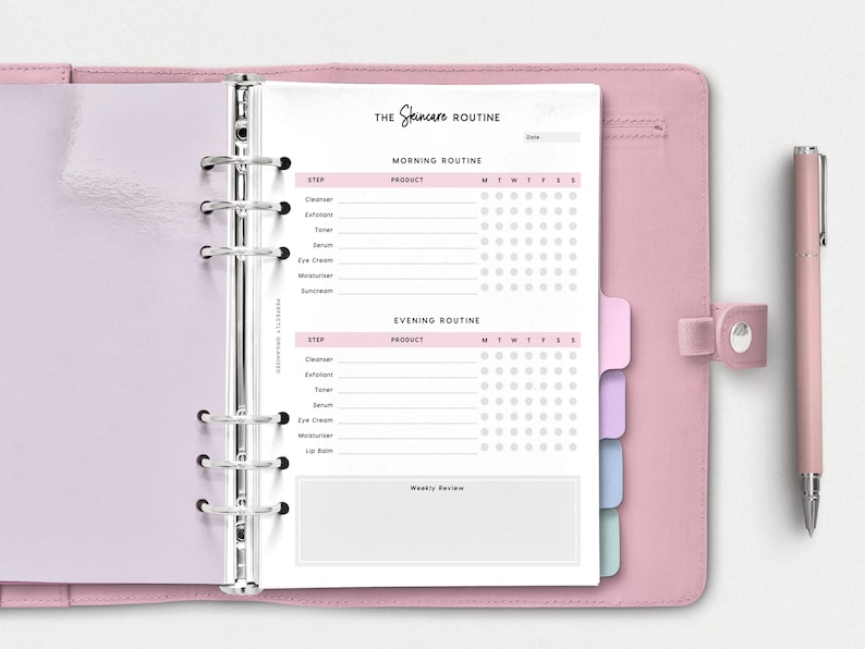 May include: A pink and white planner with a tabbed section for a skincare routine. The planner has a section for morning and evening routines, with a checklist for each step. The planner also has a section for weekly reviews.