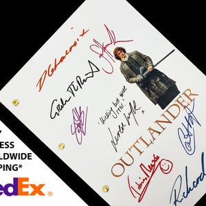 May include: A white script page from the TV show "Outlander" with signatures from the cast members. The signatures are in black, blue, red, and purple ink. The signatures include: Caitriona Balfe, Sam Heughan, Graham McTavish,  and  Tobias Menzies. The page also includes a photo of Sam Heughan in character as Jamie Fraser.