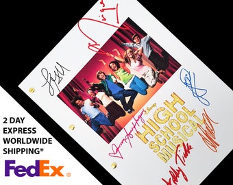 May include: A white script with the title "High School Musical" in colorful letters with a group of actors jumping in front of a red curtain. The script is signed by Zac Efron, Vanessa Hudgens, Ashley Tisdale, and Corbin Bleu.