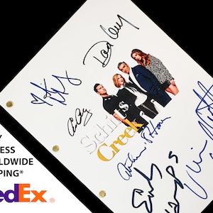 May include: A signed script from the TV show "Schitt's Creek" featuring the main cast. The script is white with black text and a photo of the cast. The signatures are in blue ink.
