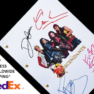 May include: A white script with the title "Descendants" and a Disney logo. The script is signed by four people in blue, red, and black ink. The script features a photo of four people in colorful costumes.