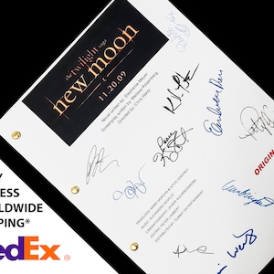 May include: A white script with the title "The Twilight Saga: New Moon" and the date "11.20.09". The script is signed by several people, including Stephenie Meyer, Melissa Rosenberg, and Chris Weitz.