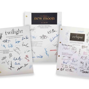 May include: Three signed screenplays from the Twilight Saga film series. The screenplays are for Twilight, New Moon, and Eclipse. Each screenplay features the title of the film and the names of the cast and crew members in black ink.