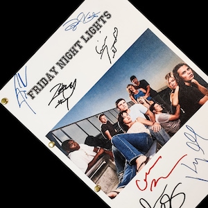 May include: A white script with the title "FRIDAY NIGHT LIGHTS" in blue and black lettering. The script is signed by the cast of the TV show, including Kyle Chandler, Connie Britton, and Taylor Kitsch. The script features a photo of the cast on a rooftop.