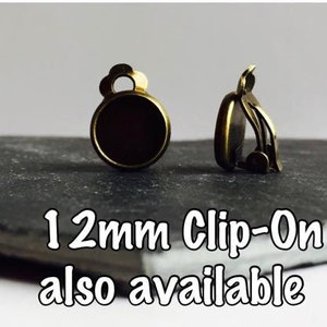 May include: Two gold-toned clip-on earring findings with a 12mm round setting. 12mm Clip-On also available.
