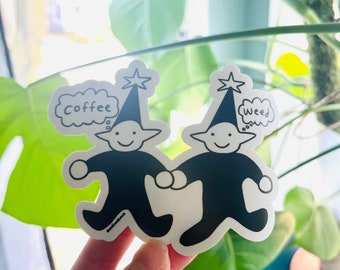 May include: Two black and white cartoon characters wearing pointy hats with stars on top. The character on the left has a thought bubble above its head that says "Coffee". The character on the right has a thought bubble above its head that says "Weed".