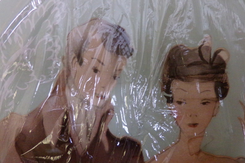 May include: A vintage illustration of a couple, a man and a woman, with a plastic sheet covering the image. The man is wearing a brown suit and the woman is wearing a white dress with a brown hat.