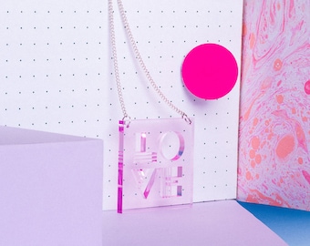 Unique pink LOVE typographic statement necklace made from transparent acrylic