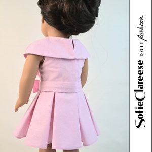 May include: A pink dress with a white collar and a bow at the waist. The dress has pleats in the skirt and is made for a doll.