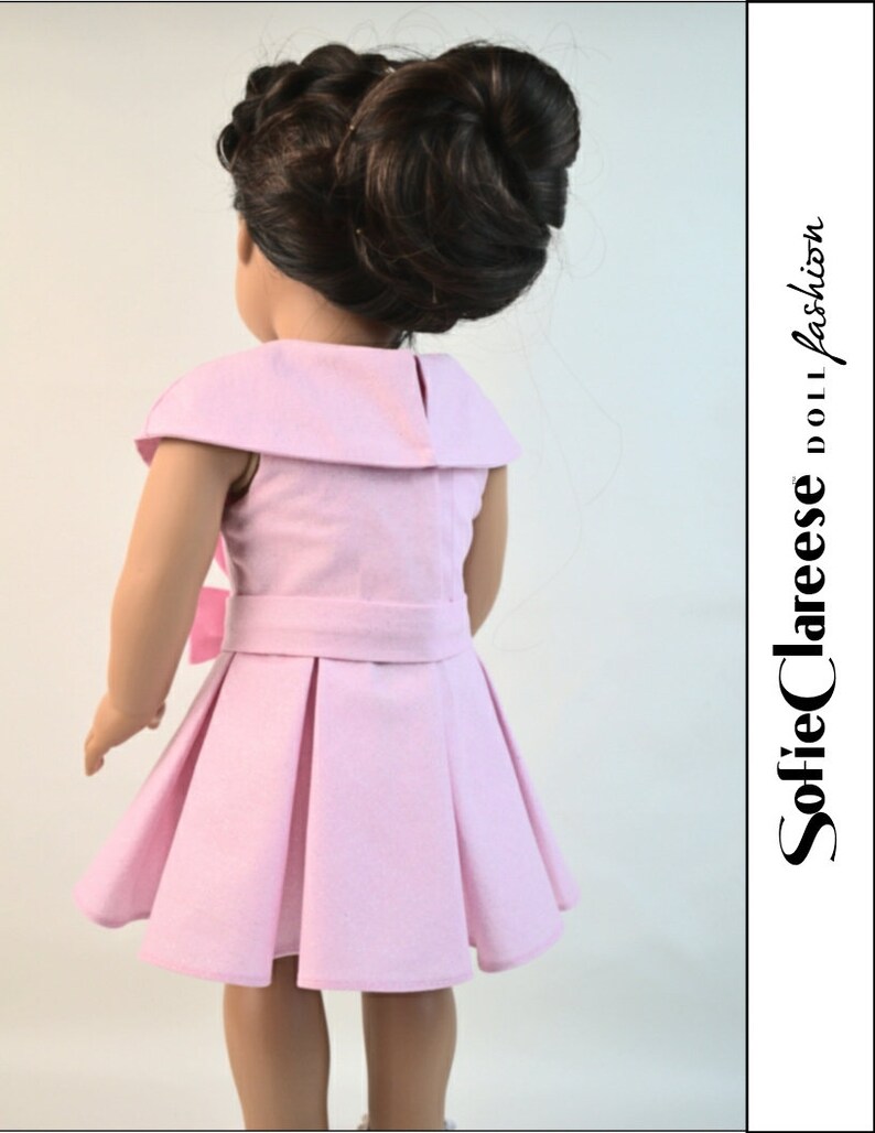 May include: A pink dress with a white collar and a bow at the waist. The dress has pleats in the skirt and is made for a doll.