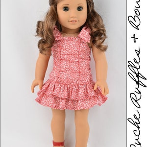 May include: A red and white floral print dress with ruffles and bows. The dress is worn by a doll with brown hair and brown eyes.
