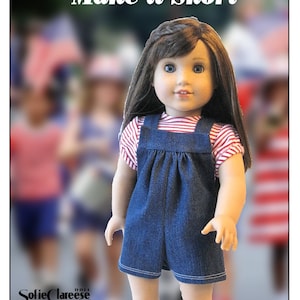 May include: A doll wearing a red and white striped shirt and denim overalls with a gathered waist. The doll has long brown hair and blue eyes. The background is blurred and shows other dolls.