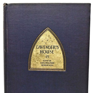 May include: A dark blue hardcover book with a gold-colored title on the front. The title reads "Cavender's House" by Edwin Arlington Robinson.