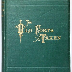May include: A vintage hardcover book titled "The Old Forts Taken." The cover is a deep green with gold lettering and decorative flourishes. The spine has the title in vertical gold lettering. The book's design suggests a historical or classic theme.