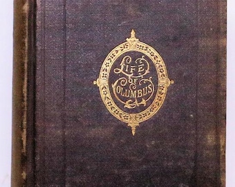 May include: Antique book titled "Life of Columbus" with a dark brown cover. The cover features a gold oval emblem with the title's text. The book's spine is a lighter brown, and the edges show wear.