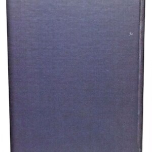 May include: A dark blue hardcover book with a smooth, textured cover.