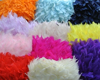 May include: Assortment of colorful feather boas in various colors, including orange, light blue, navy blue, lavender, white, pink, fuchsia, purple, red, and cream.