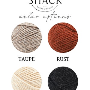 May include: Four yarn balls in different colors: taupe, rust, off white, and black. The yarn balls are arranged in two rows of two. The text "Three Sheep Shack" is at the top of the image. The text "Color Options" is below the yarn balls.