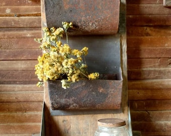 Vertical wall planter boxes repurposed conveyor cups on vintage Wood shelf.