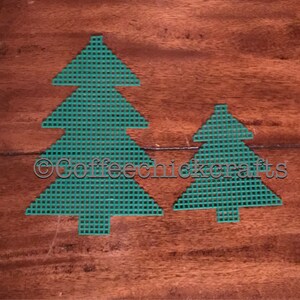 May include: Two green felt Christmas tree shapes on a wood background. The larger tree is taller than the smaller tree. The text "©Coffeechickcrafts" is visible in the image.